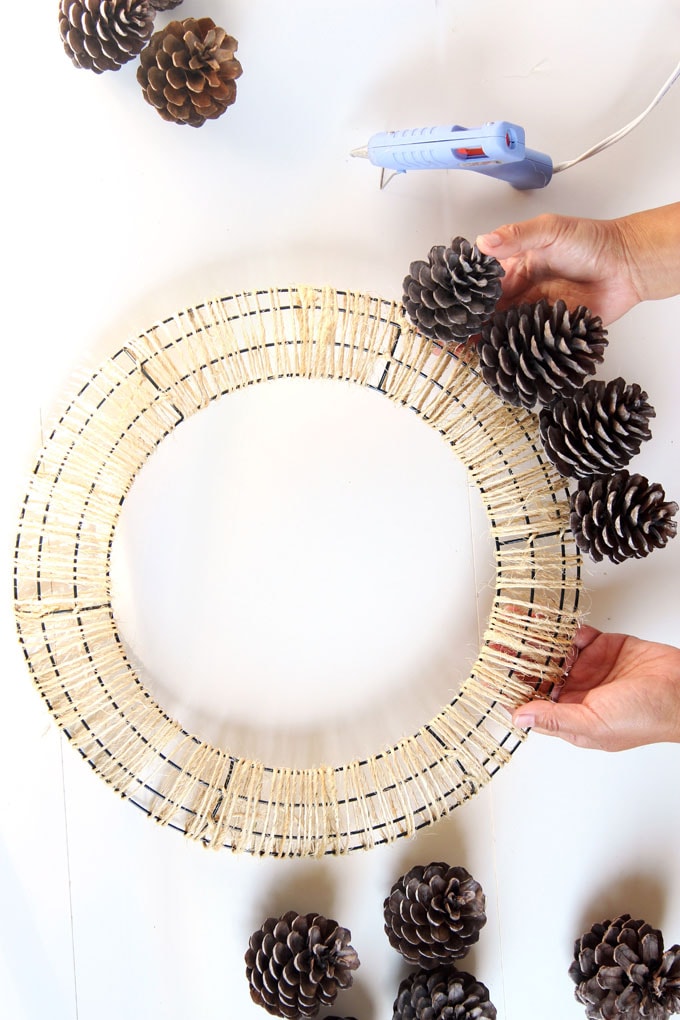 Start Gluing The Pine Cones All Around The Wreath